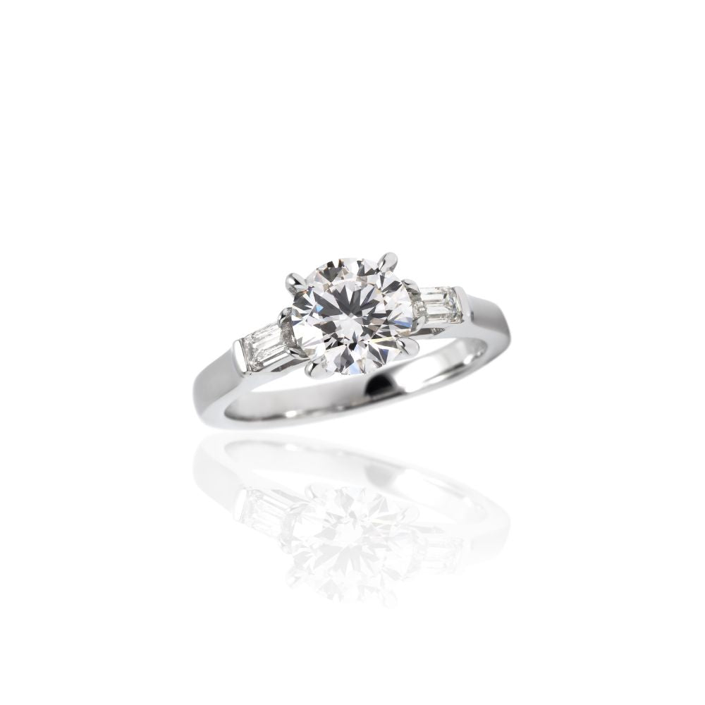 １カラットラウンド３ストーンリング （サイドエメラルドカット）